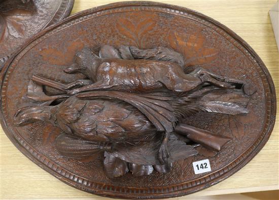 A pair of carved wood plaques